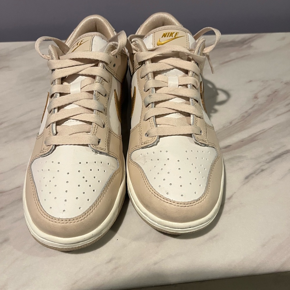 Nike Low-Top Sneakers in Cream & Metallic Gold Accents